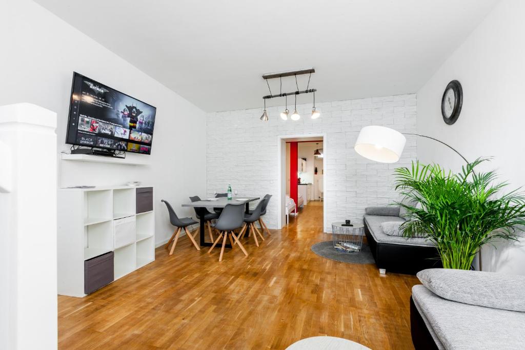 a living room with a table and a couch at DR APARTMENTS in Berlin
