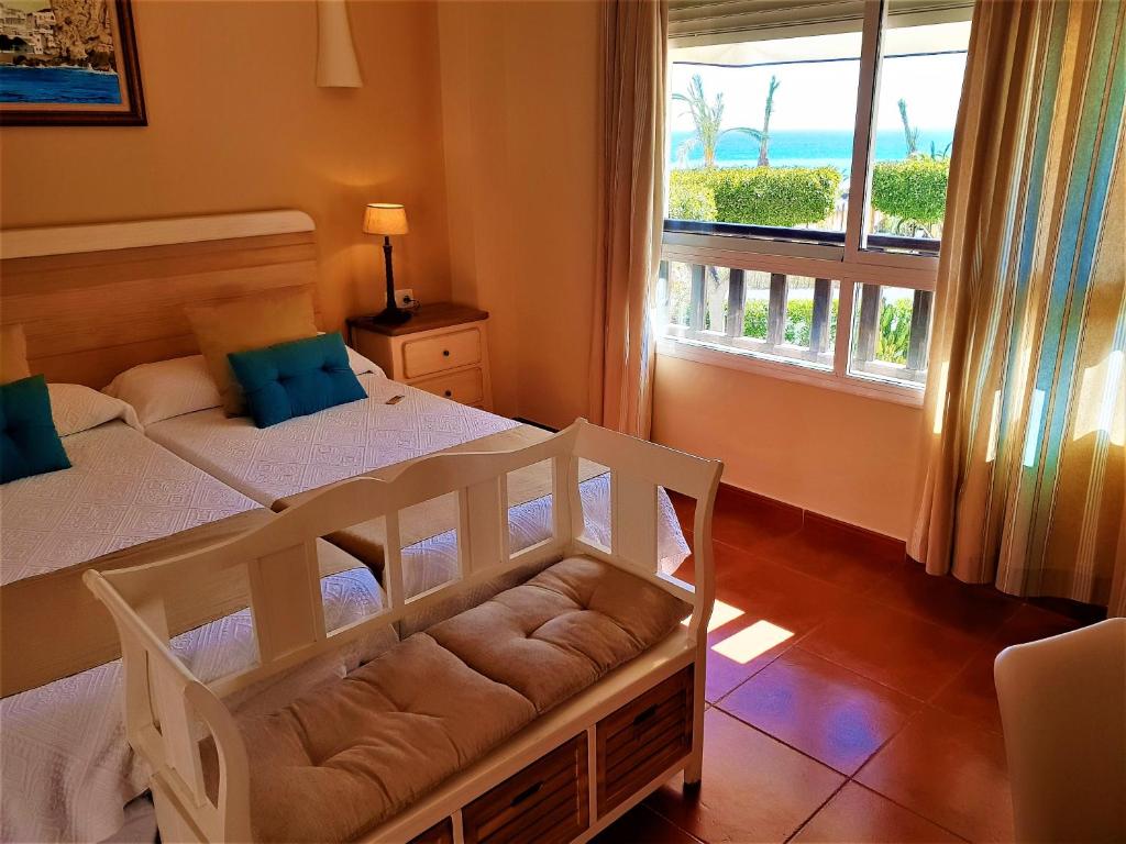 a bedroom with a bed with a view of the ocean at Hotel las Calas in Agua Amarga
