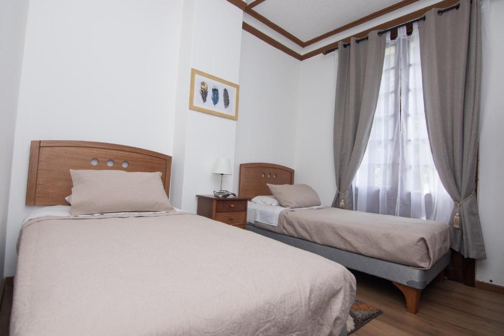Postel nebo postele na pokoji v ubytování Lucia Agustina Hotel Boutique