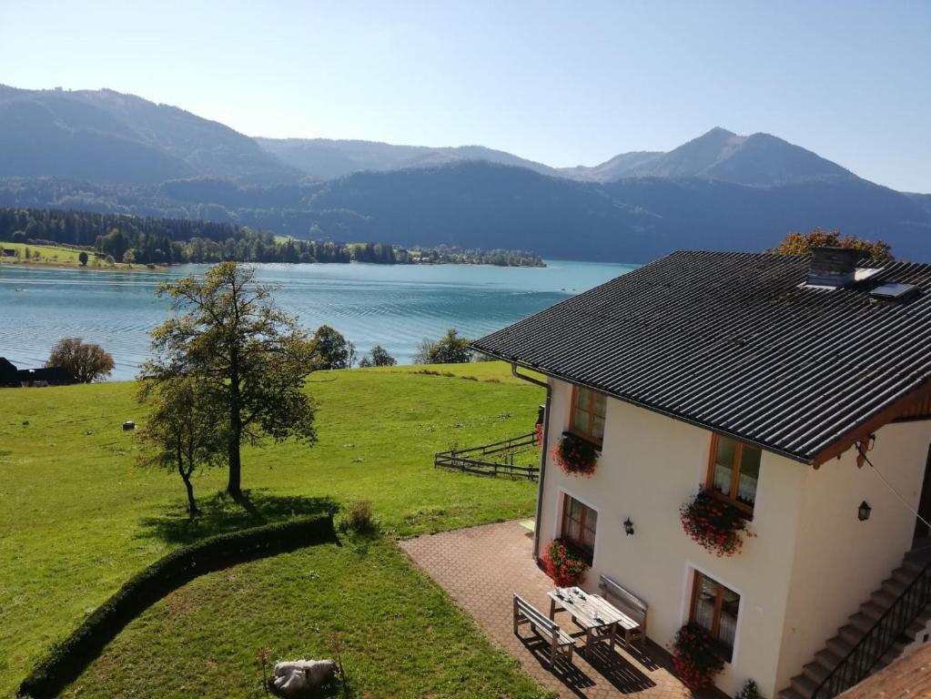 a house with a view of a lake and mountains at Berningerhof in St. Wolfgang