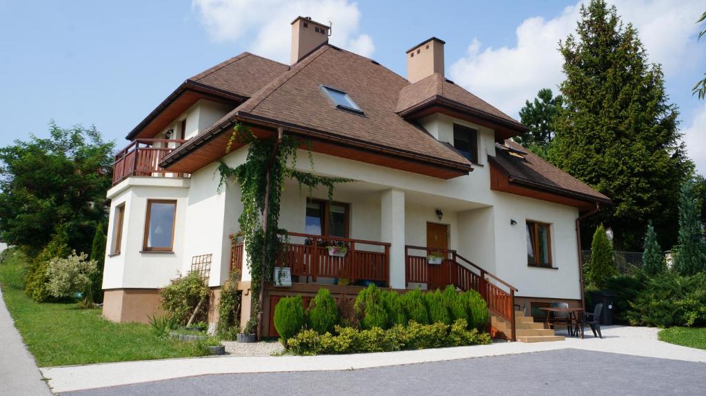 a white house with a brown roof at Calm House in suburbs of Cracow in Michałowice