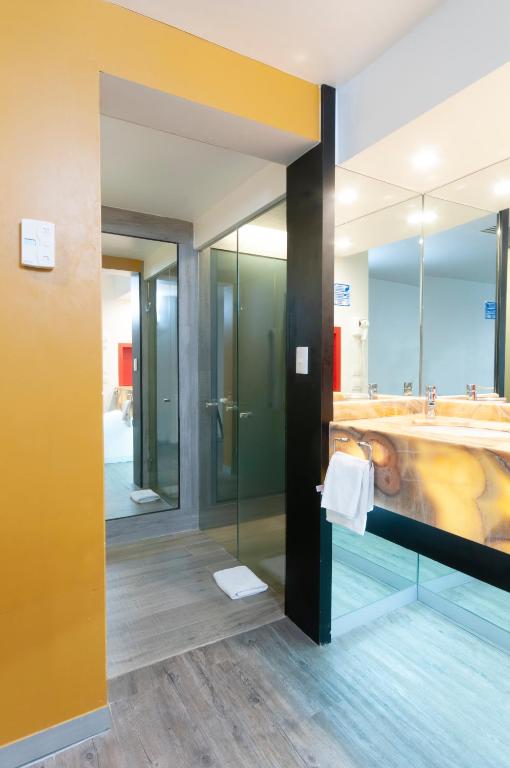 A bathroom vanity and glass-enclosed shower area with a full-width mirror.