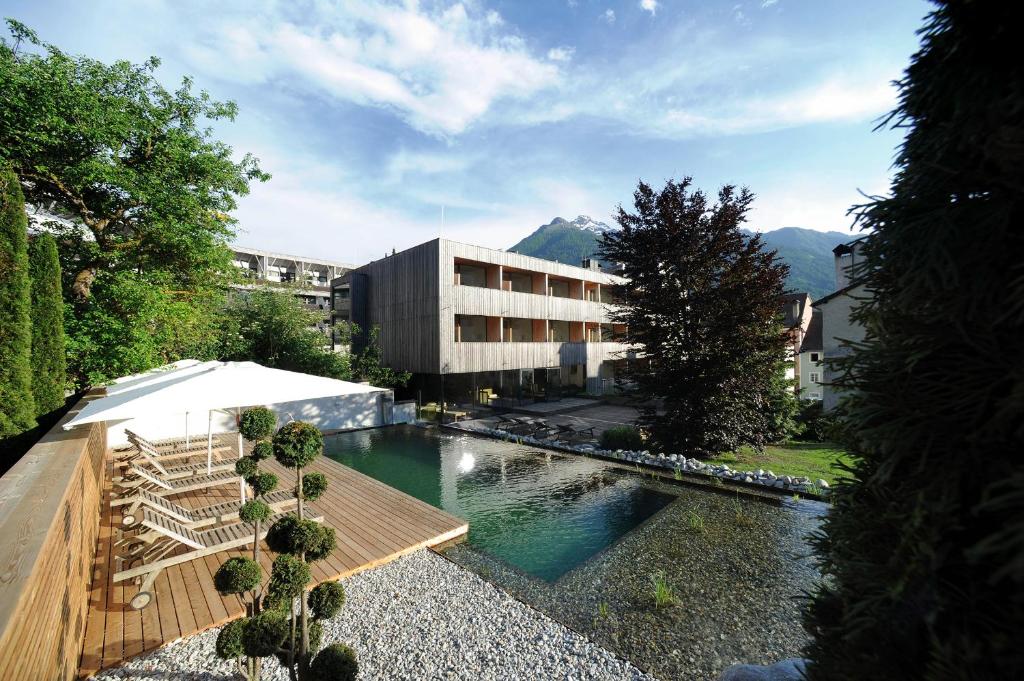 a swimming pool in front of a building at Hotel Hinteregger in Matrei in Osttirol