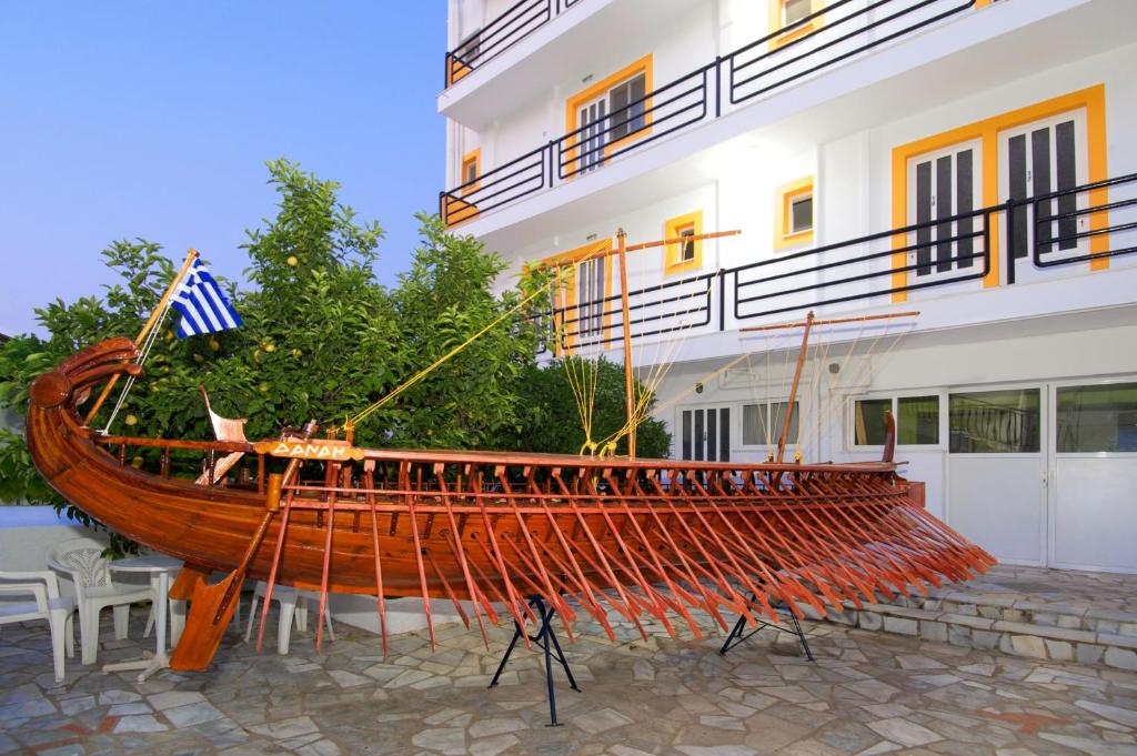 a large wooden boat on display in front of a building at Remezzo Apartments in Sami