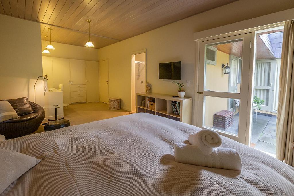 a bedroom with a bed with a towel on it at Cygnet, Studio on Sturt in Wendouree