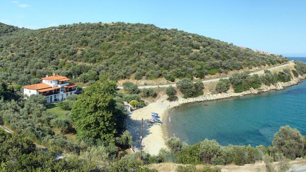 a house on a hill next to a body of water at Gialaki in Pyrgadikia