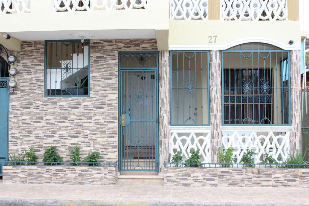 a front door of a house with blue doors at Elisa Furnished Apartments (Puerto Plata City) in San Felipe de Puerto Plata