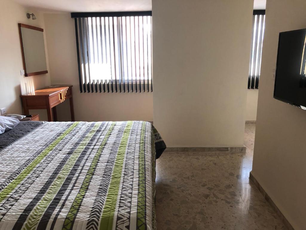 Postel nebo postele na pokoji v ubytování Hotel Pastora