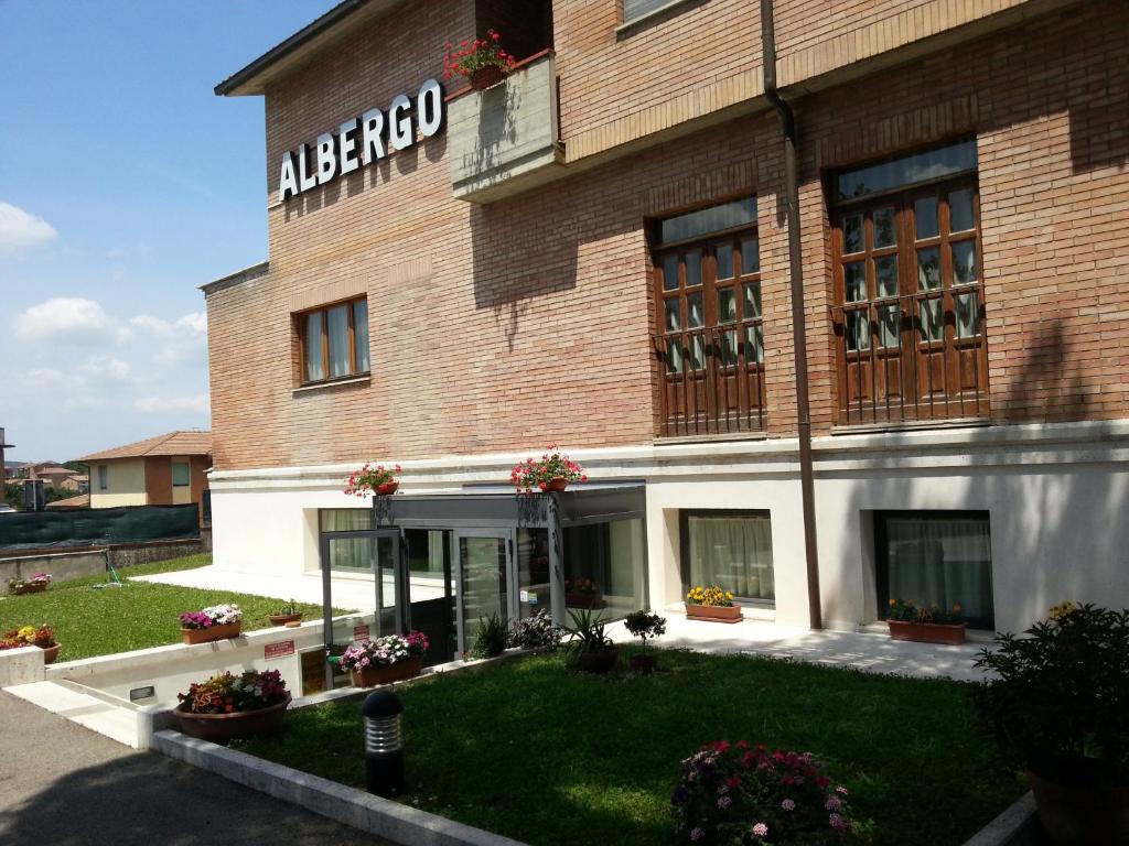 a building with a sign on the side of it at Hotel I Platani in Siena