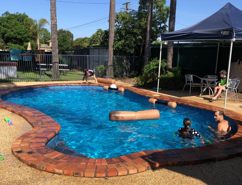 a group of people in a swimming pool at Tamworth Central Motel in Tamworth