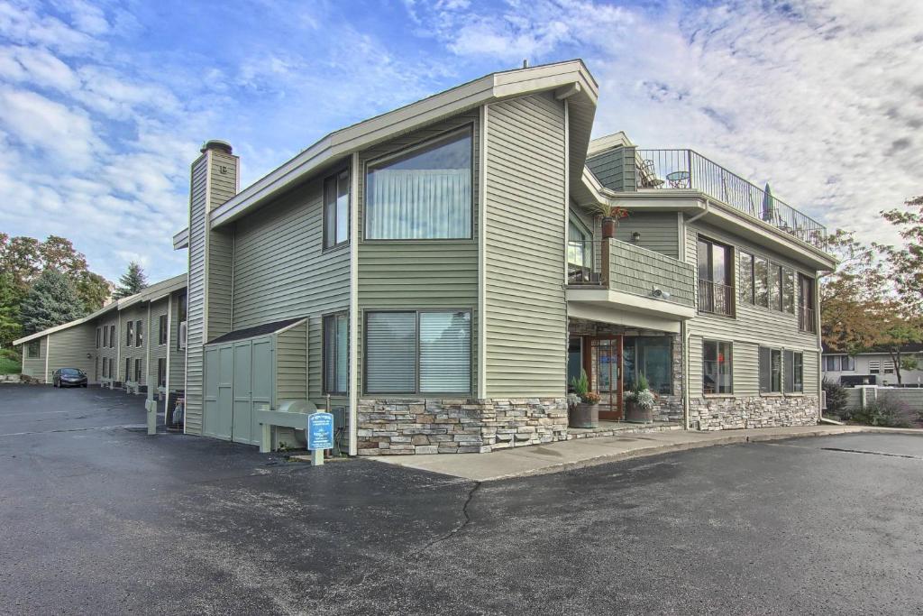 a large house with a parking lot in front of it at 110 Pointes North Inn in Charlevoix