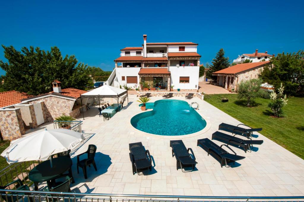 an external view of a house with a swimming pool at Villa Kimberly in Rovinj