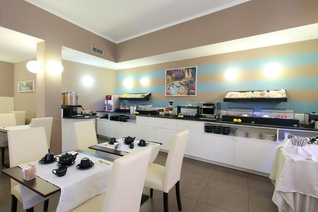 a restaurant with a table and chairs and a counter at Hotel Margherita in Monterosso al Mare