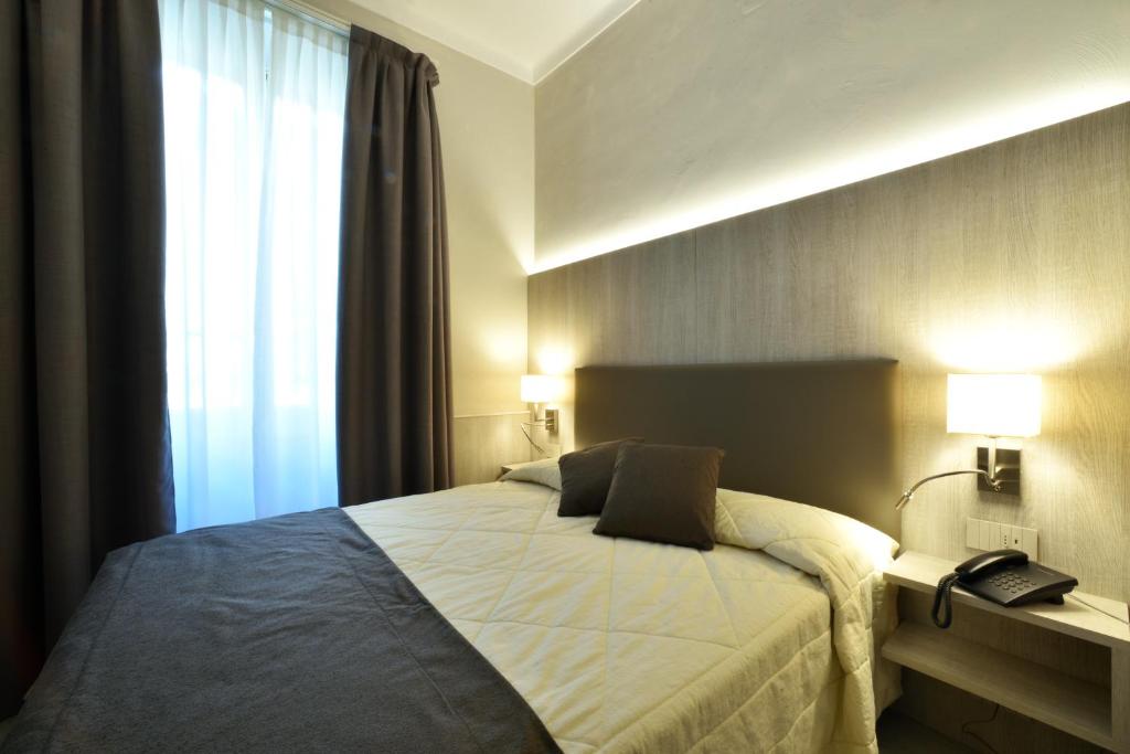 Кровать или кровати в номере Hotel Lamberti