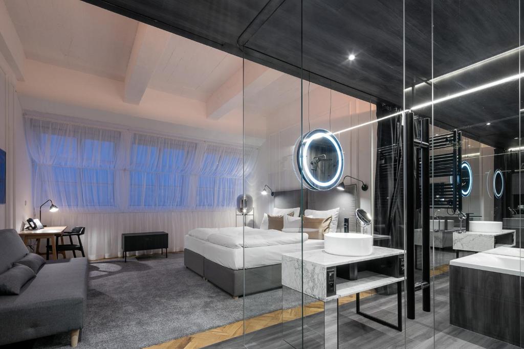 a bathroom with a bed and a sink at Pytloun Boutique Hotel Prague in Prague