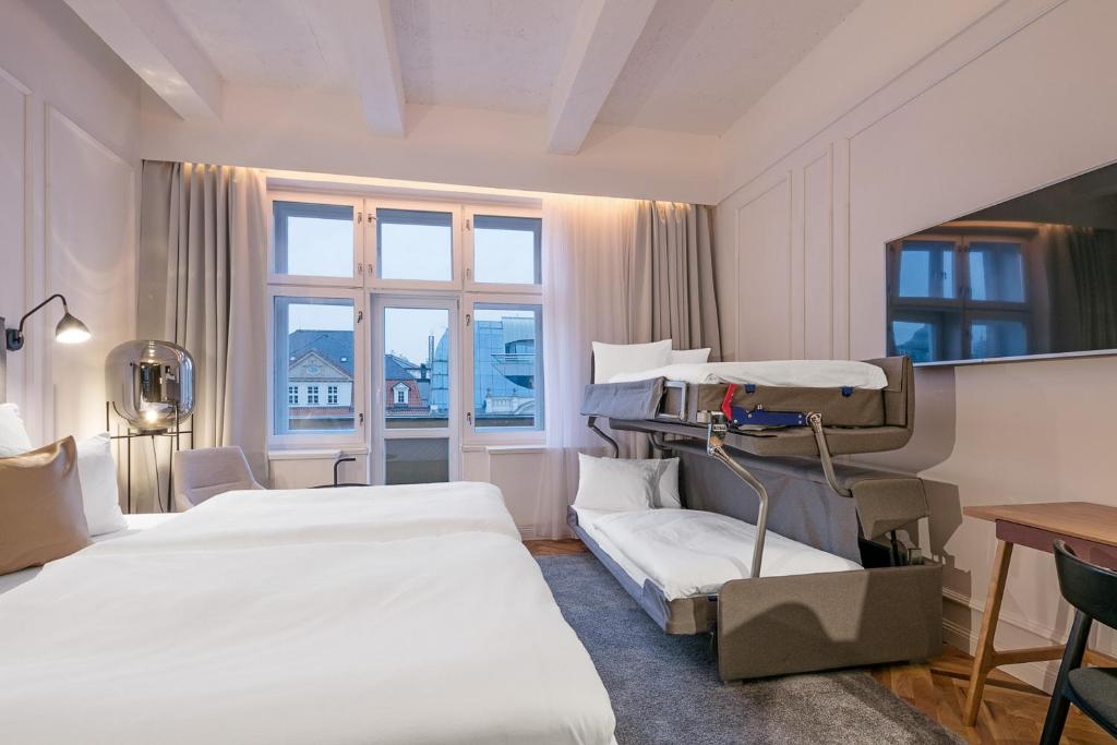 a hotel room with two beds and a window at Pytloun Boutique Hotel Prague in Prague