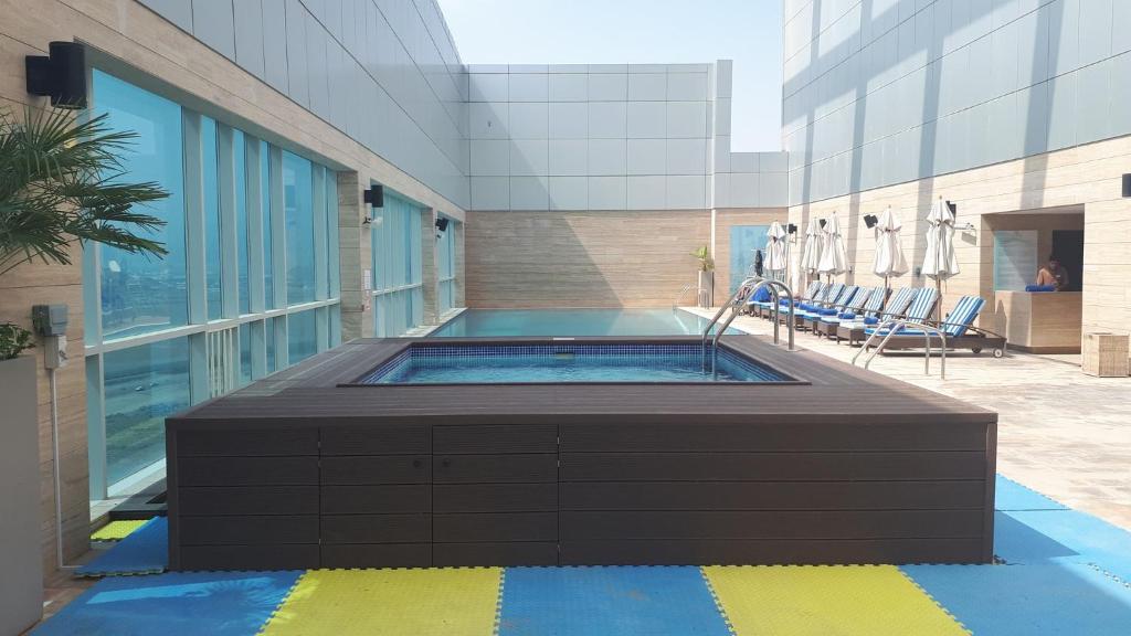 a swimming pool in the middle of a building at Royal M Hotel Fujairah by Gewan in Fujairah