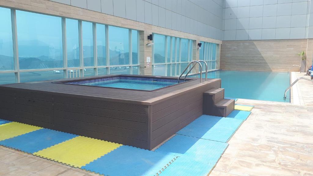 a swimming pool with a hot tub in a building at Royal M Hotel Fujairah by Gewan in Fujairah
