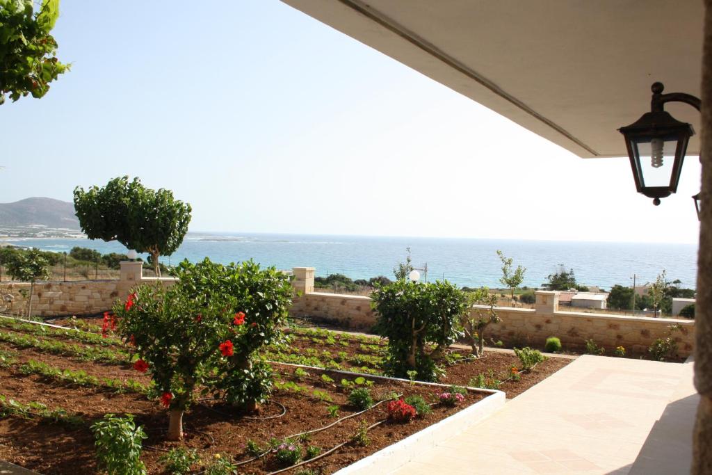 a garden with a view of the ocean at Romantica Apartments in Falasarna