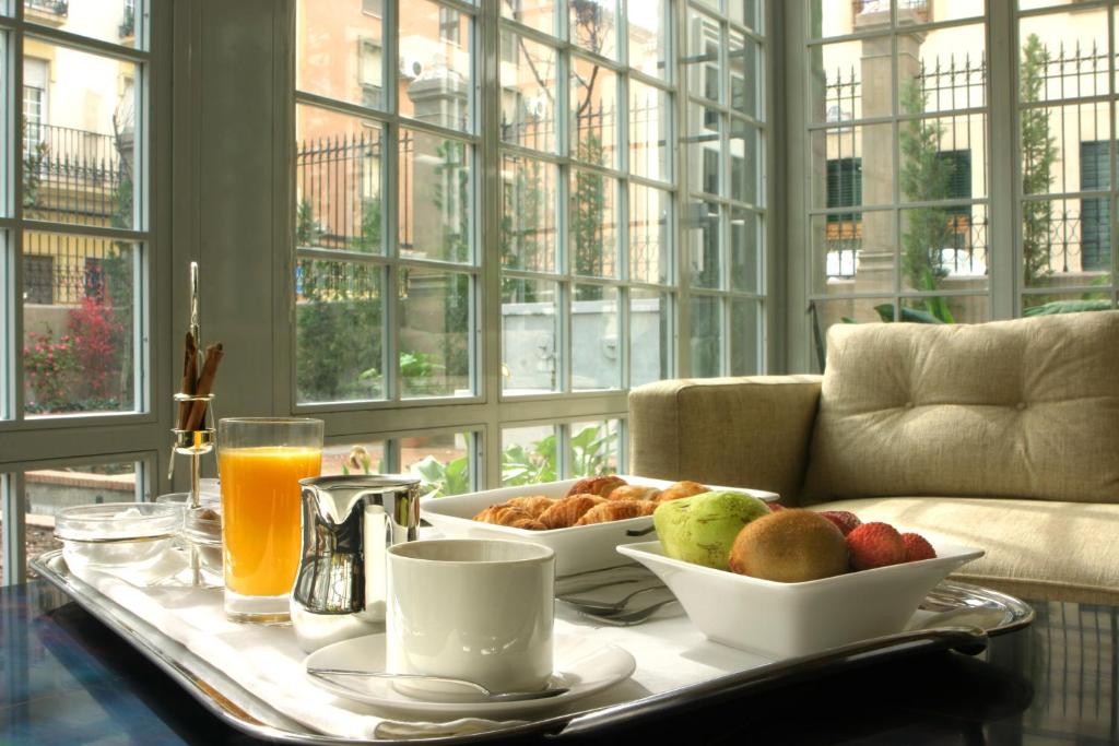 a breakfast table with a tray of food and drinks at Villa Oniria in Granada