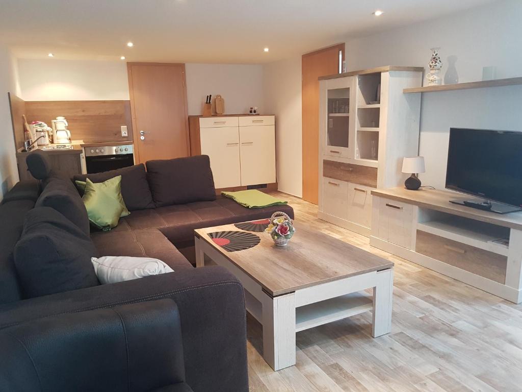 a living room with a couch and a coffee table at Ferienhaus Am Graseberg in Neinstedt
