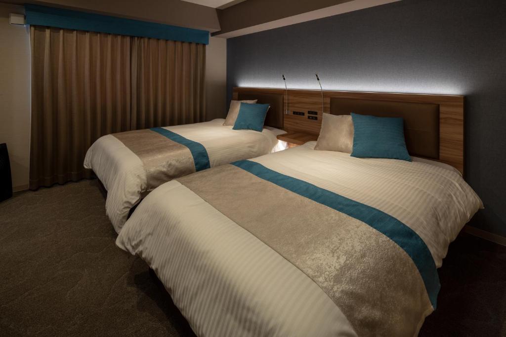Postel nebo postele na pokoji v ubytování Wat Hotel & Spa Hida Takayama