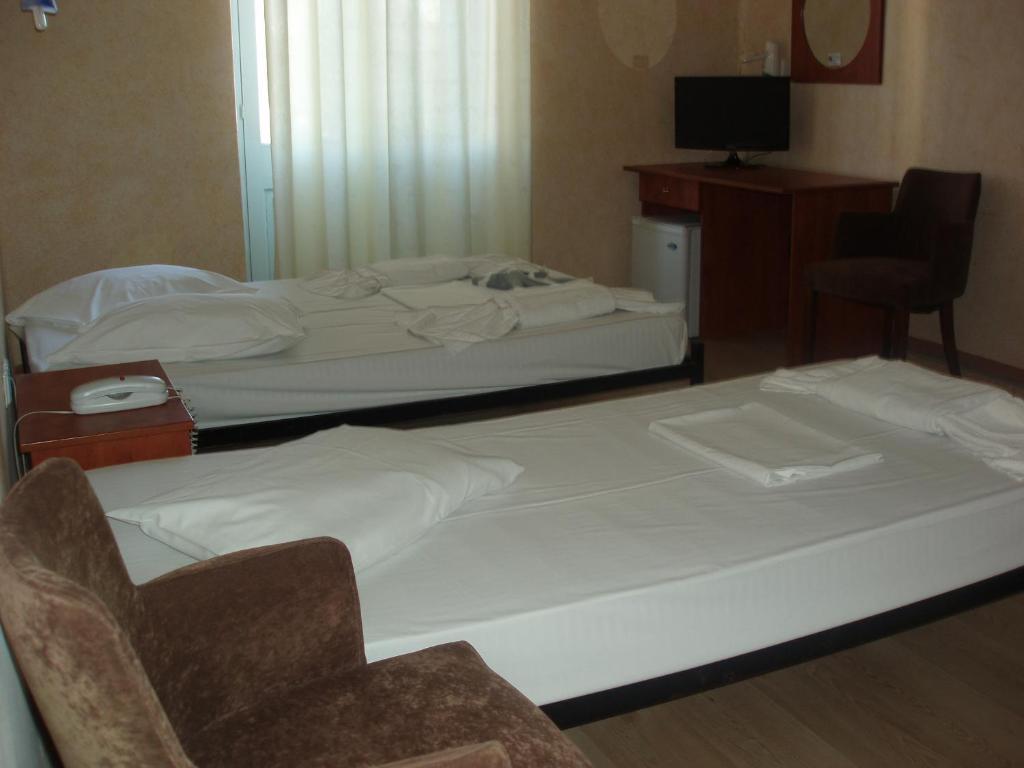Postel nebo postele na pokoji v ubytování Orfeas Hotel