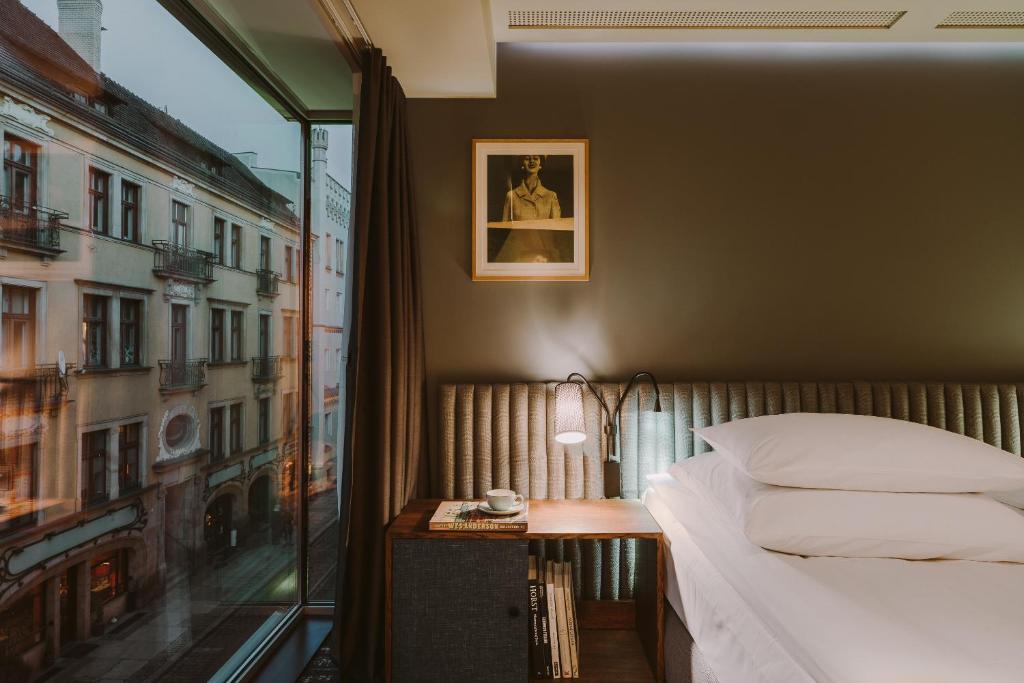 a hotel room with a bed and a desk at PURO Wrocław Stare Miasto in Wrocław