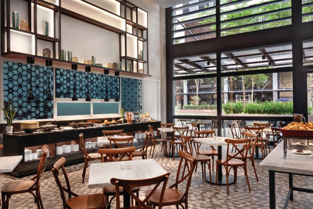 A bright breakfast dining room with a buffet counter and garden-facing windows.