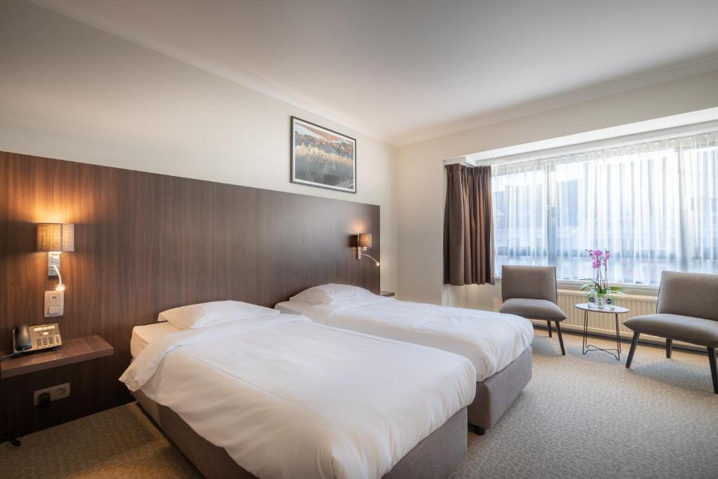 Postel nebo postele na pokoji v ubytování Hotel Carlton