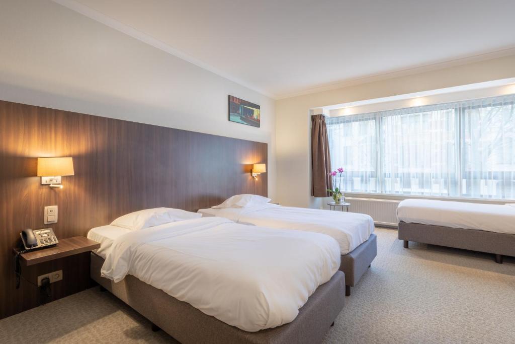 Postel nebo postele na pokoji v ubytování Hotel Carlton