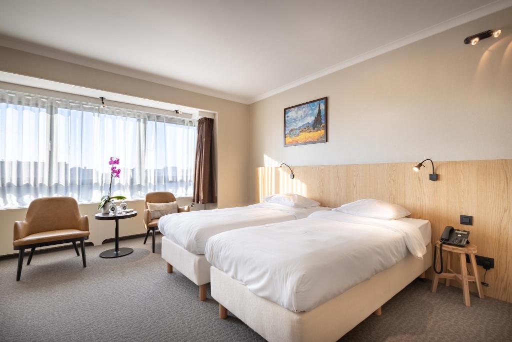 Postel nebo postele na pokoji v ubytování Hotel Carlton