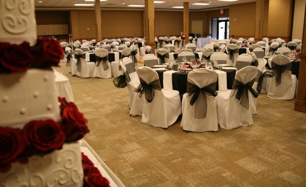 a room full of tables and chairs with white and black bows at Country Inn & Suites by Radisson, Lincoln North Hotel and Conference Center, NE in Lincoln