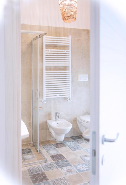 a bathroom with two toilets and a sink at Fabrì 171 in Pescara