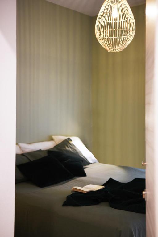 a bedroom with a large bed with a chandelier at Fabrì 171 in Pescara