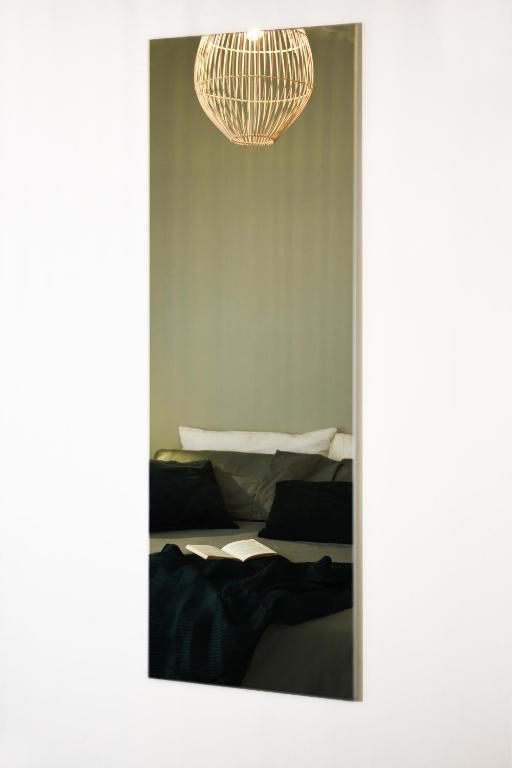 a reflection of a bedroom with two beds and a chandelier at Fabrì 171 in Pescara
