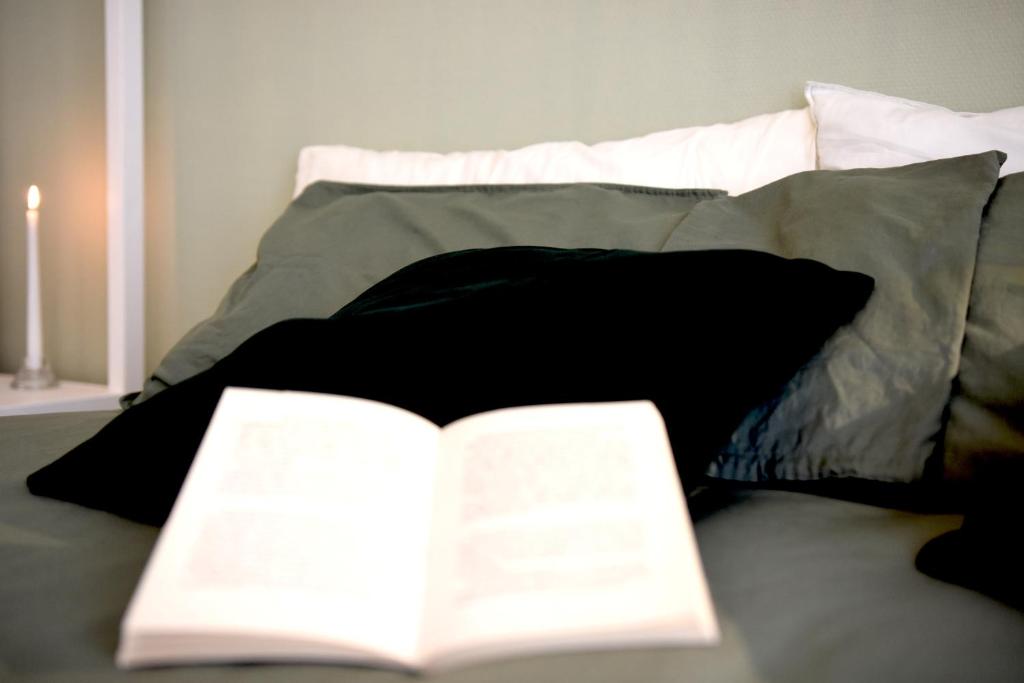 an open book sitting on top of a bed at Fabrì 171 in Pescara