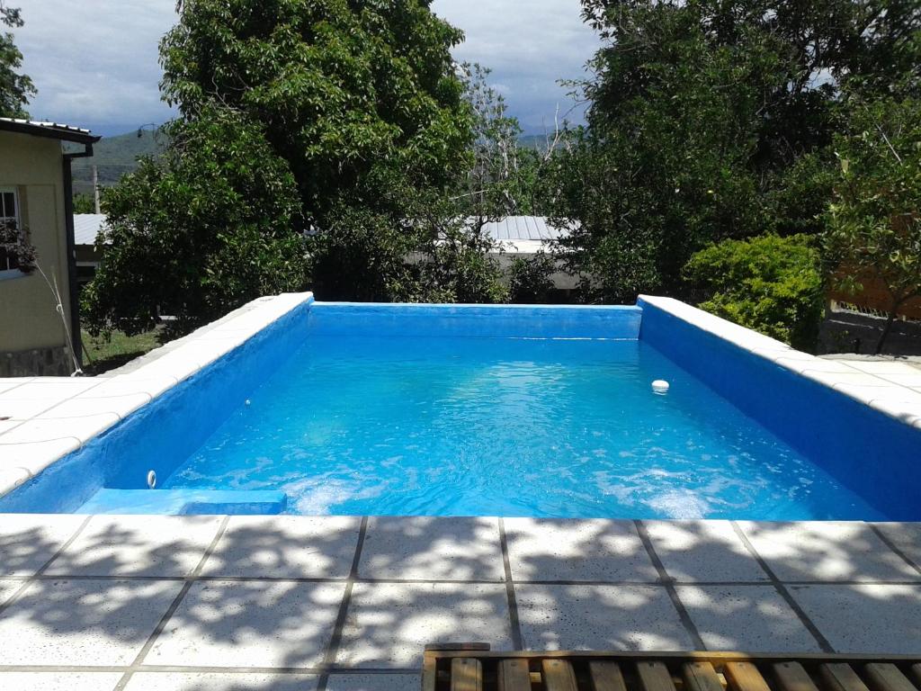 a small blue swimming pool in a yard at Terrazas del Wayra in La Carrera