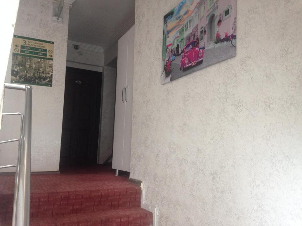 a hallway with stairs and a picture on the wall at Yalçın Otel in Antalya