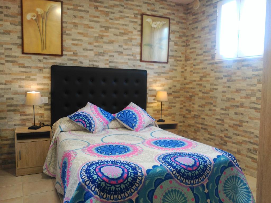 1 dormitorio con 1 cama con 2 mesas y 2 lámparas en ESTUDIO FAMILIAR En EZCARAY, en Ezcaray