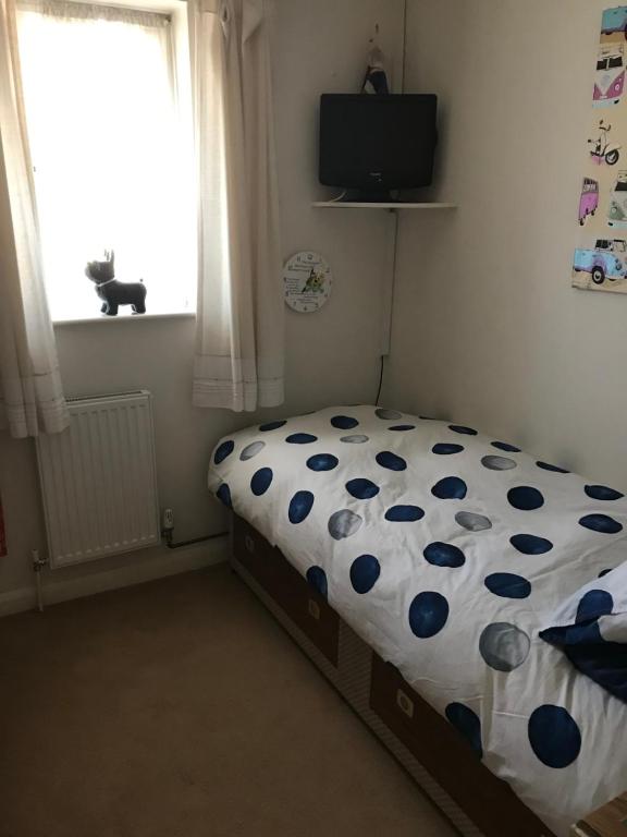 a bedroom with a bed with a polka dot sheet at J8 m27 in Southampton
