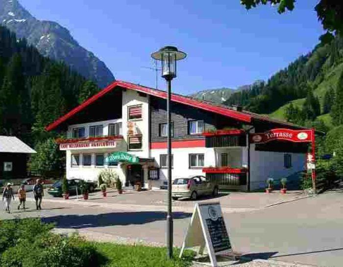 a building with a street light in front of it at Norishütte in Mittelberg