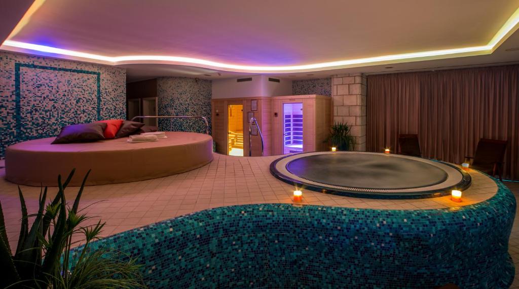 a room with a large tub in the middle at Hotel Marina in Izola
