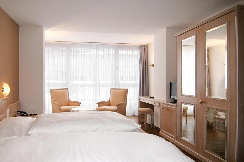 Postel nebo postele na pokoji v ubytování Wellnesshotel Schweizerhof