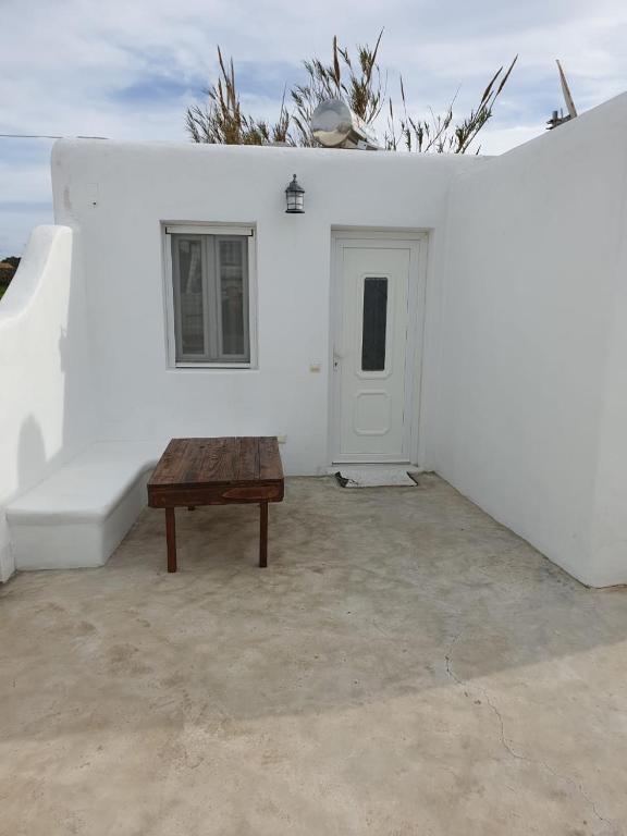 a room with a table and a white wall at Maya Apartments in Dexamenes