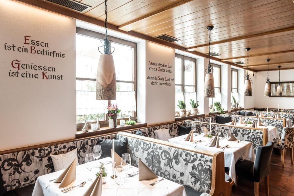 a row of tables in a restaurant at Hotel Ariadne in Rosenheim