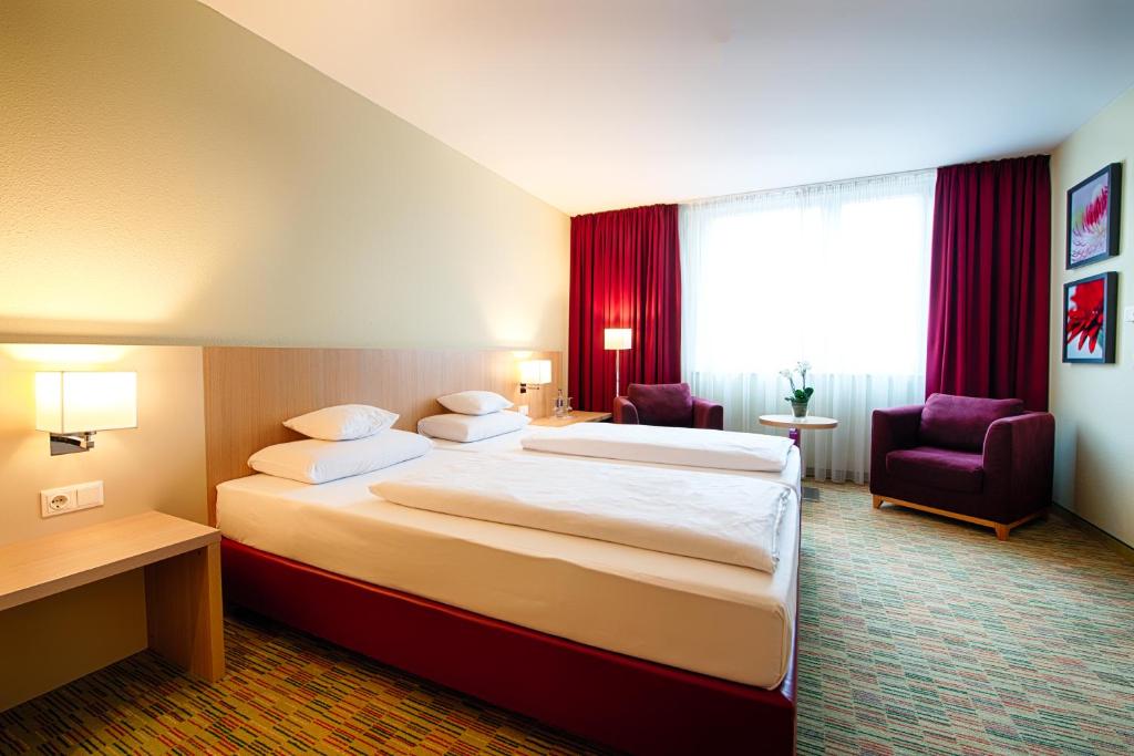 Postel nebo postele na pokoji v ubytování Welcome Hotel Paderborn