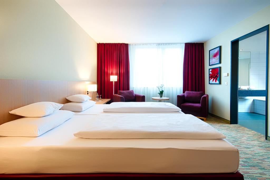 Postel nebo postele na pokoji v ubytování Welcome Hotel Paderborn