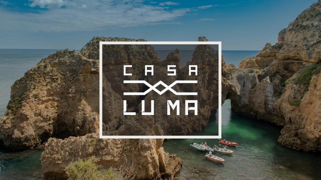 a group of boats on the water near a cliff at Casa Luma B&B in Lagos