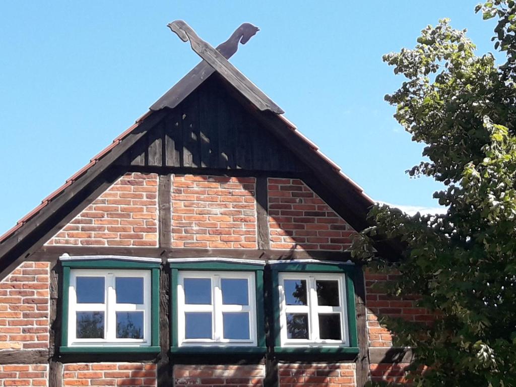 a cross on the roof of a brick building at Pension up´n Dörp in Plattenburg